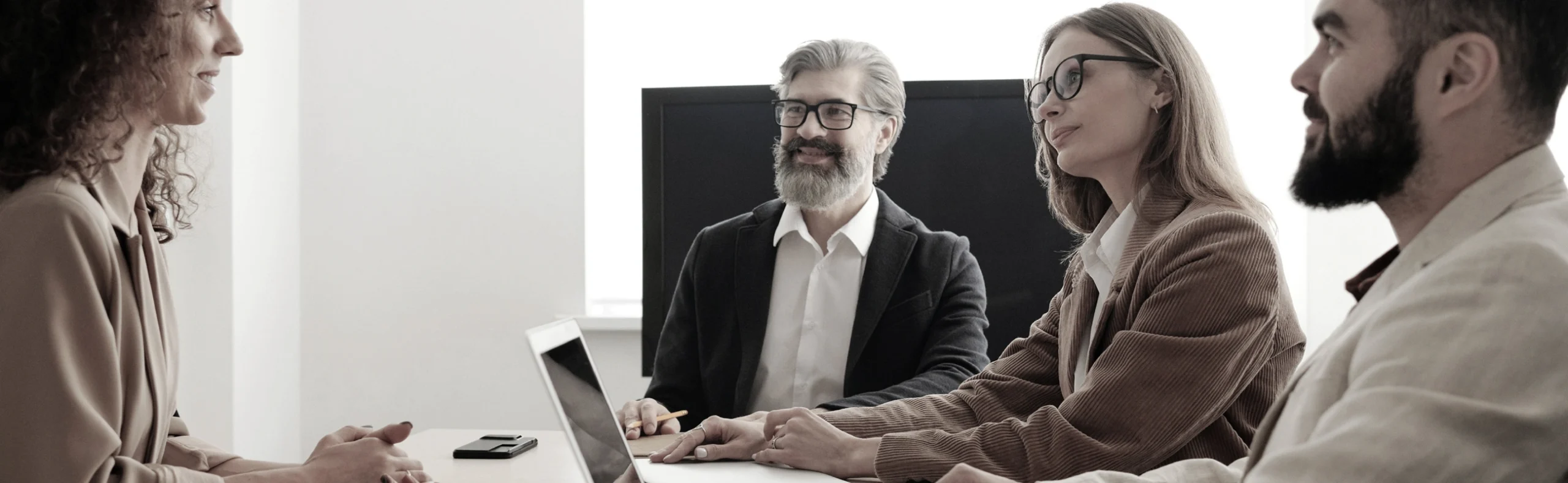 Business meeting with diverse professionals discussing legal services, showcasing collaboration and expert guidance in business law.