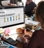 “Risk Assessment for Small Businesses – Legal Protection & Compliance Services | The Law Offices of Paul H. Appel” Person engaged in risk assessment at a desk, analyzing charts on a computer screen, emphasizing construction law and compliance in New Jersey.