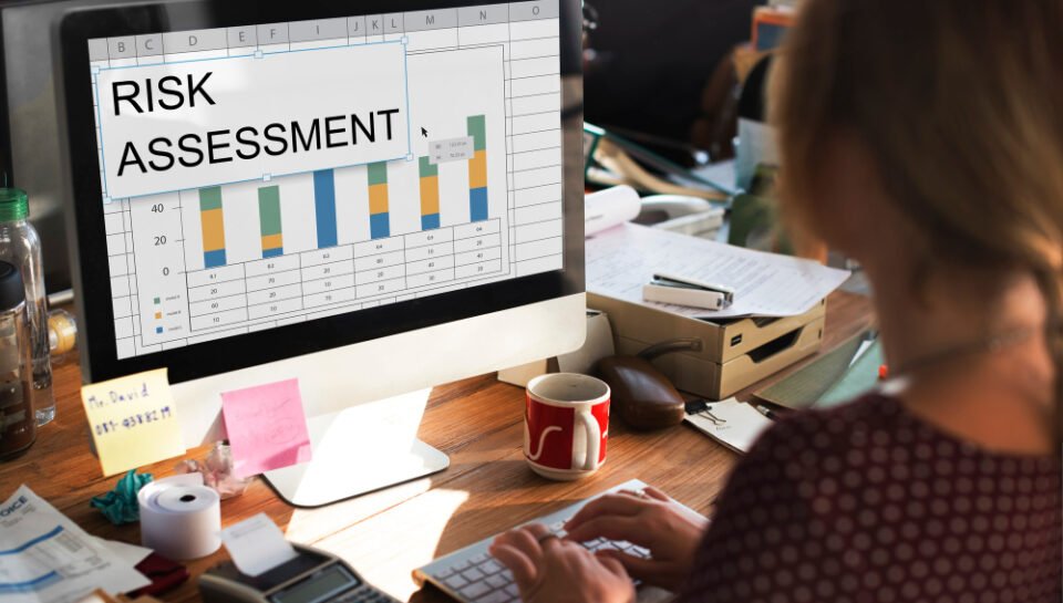 “Risk Assessment for Small Businesses – Legal Protection & Compliance Services | The Law Offices of Paul H. Appel” Person working on a computer displaying a risk assessment spreadsheet, surrounded by office supplies, illustrating the need for ongoing legal compliance and risk management for small businesses.