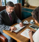 Business attorney providing professional legal guidance to a client over a meeting at The Law Offices of Paul H. Appel in New Jersey.