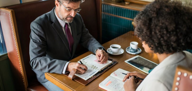 Business attorney providing professional legal guidance to a client over a meeting at The Law Offices of Paul H. Appel in New Jersey.