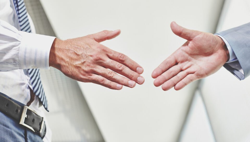 “Partnership Disputes – Business Litigation & Mediation Attorney in New Jersey”793 Hands of two business professionals about to shake, symbolizing agreements in mergers and acquisitions in New Jersey.