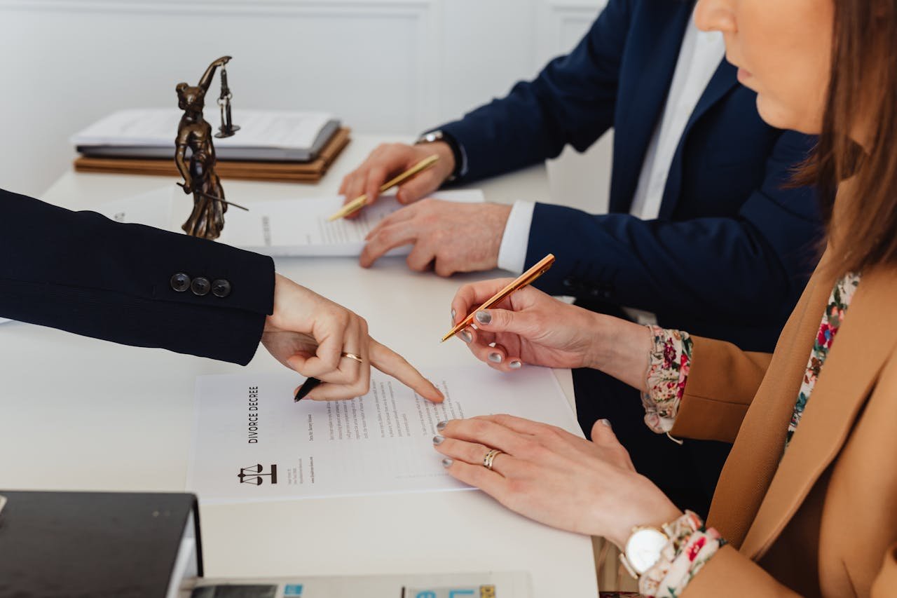 Legal professionals reviewing documents during a consultation, emphasizing contract discussions and legal agreements.