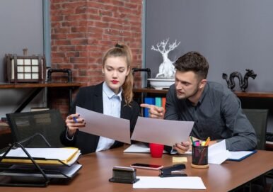 front-view-young-busy-confused-clerical-workers-discussing-one-issue-documents-office_140725-106003