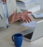 hands-unrecognizable-man-having-video-call-laptop-applauding_1098-17600