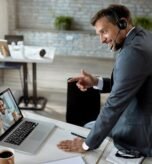 happy-businessman-using-laptop-while-having-online-meeting-with-his-coworker-office_637285-6776
