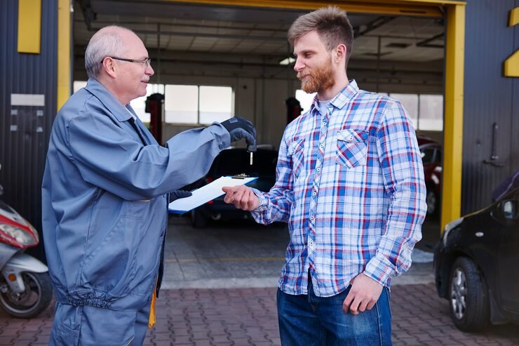 mechanic-giving-keys-car-customer_329181-11862