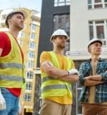 three-men-looking-aside-construction-site_259150-57679