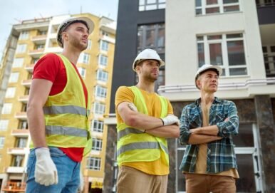 three-men-looking-aside-construction-site_259150-57679